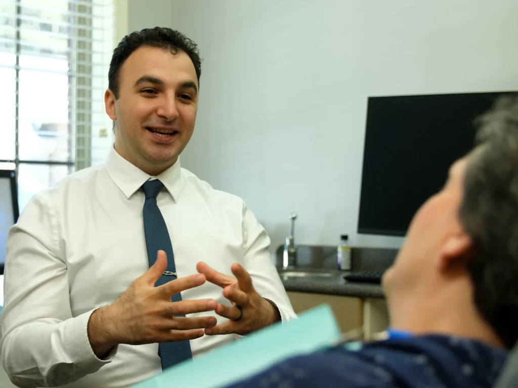 Dr. George Zohrabyan consulting with a patient at Sugarloaf Smiles, Duluth GA